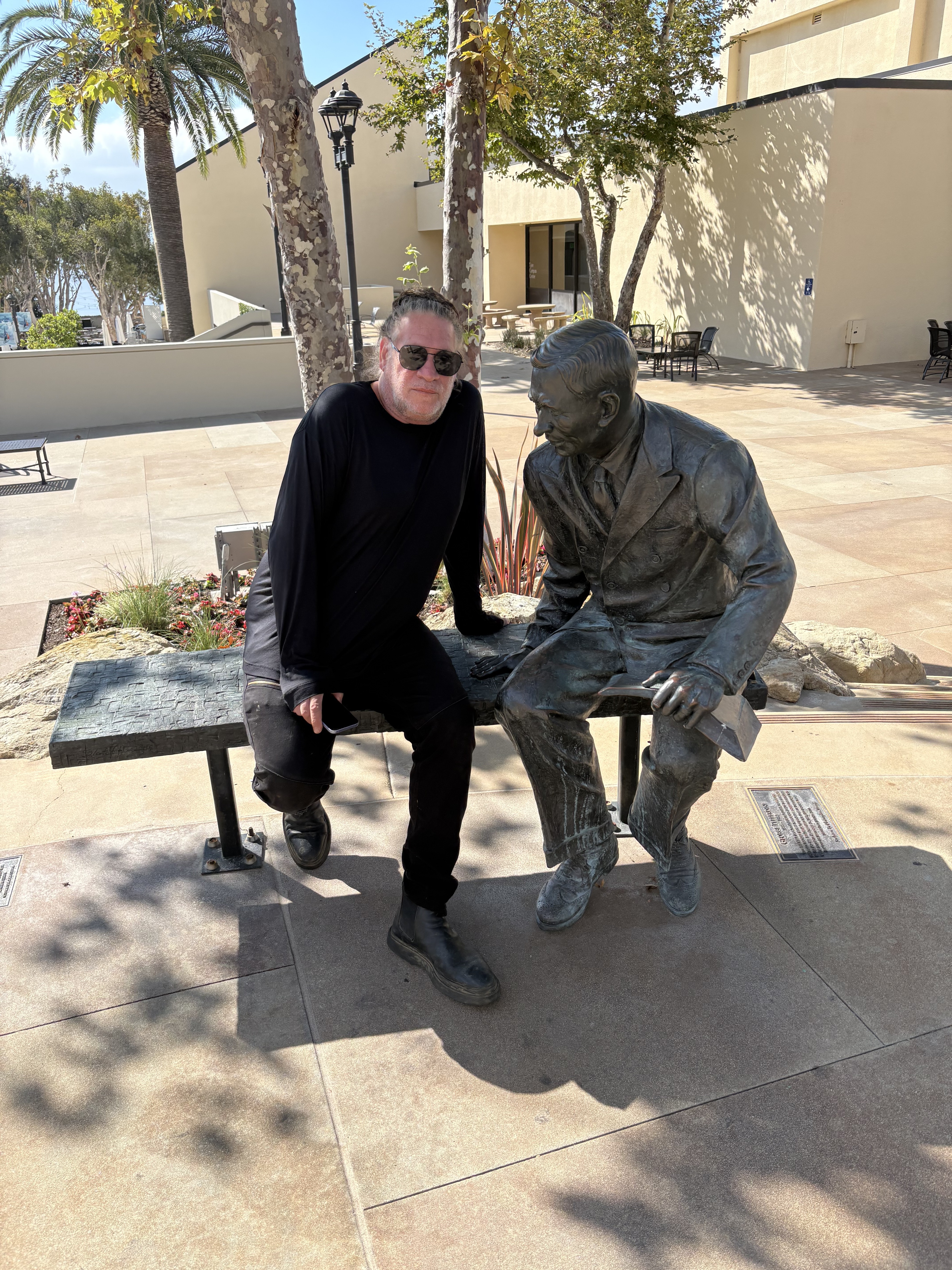 Daniel Serfaty, artist and curator, beside a bronze statue he cast